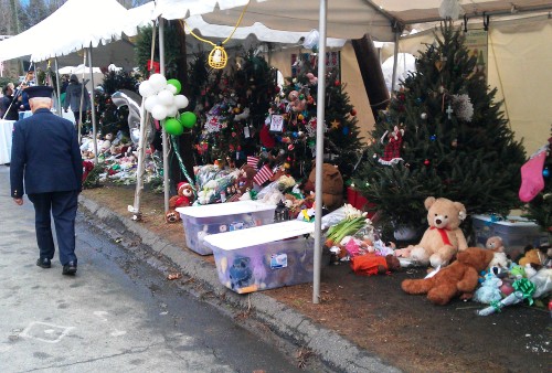 Mervin Roberts walks past the tree memorial set up in Newtown to honor the victims.