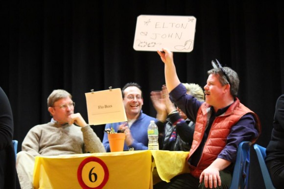 Photos courtesy of S.Crisp, LOL Education Foundation. David Rau of the Flo-Bees holds his correct answer high to the delight of his teammates.