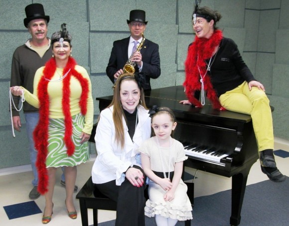 From left to right, Chris Lawrie of Landscape Specialties, Dawn Swope of Community Music School, Greg Shook of Essex Savings Bank, Pearl Twirl Event Chairman Monique Heller, Community Music School student Giovanna Parnoff and Mary Tomassetti of Landscape Specialties try out props for the Pearl Twirl 30th anniversary gala.