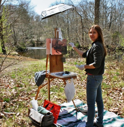 Jacqueline White of Glastonbury works on her watercolor on the banks of the Eightmile River in Lyme’s Pleasant Valley Preserve on April 27 during the Third Annual Lyme Paintout.