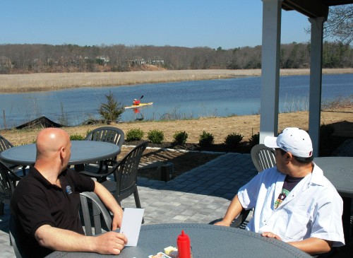 Watching the world (or in this case, a kayaker) go by from Morning Glory's inviting patio.