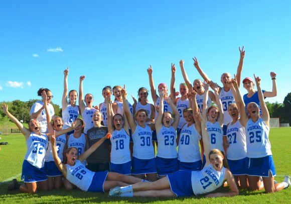 The Wildcat girl's lacrosse team celebrates after its victory over Weston on Friday.