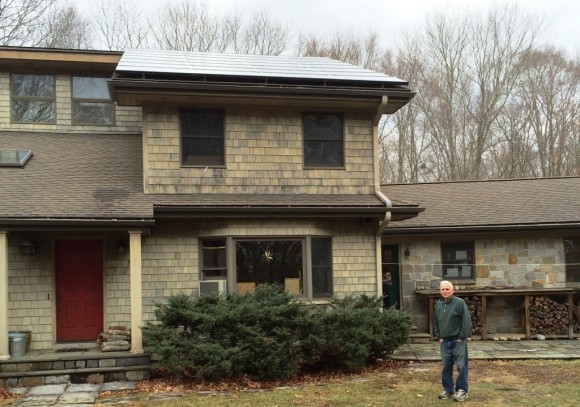 Dave McCullough stands in front of his solarized home in Old Lyme.