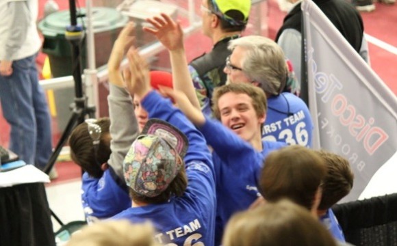 Team 236 members Aiden, Norm and Ethan celebrate as the Techno Ticks win their final game to take home the Waterbury District Championship
