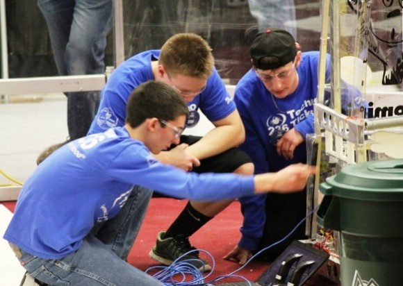 Drive Team Captain Jared Di Carlo makes some final adjustments to the robot during the contest with team members Hayden Hendrix and Nate Bersing.  All photos by Sarah Crisp.