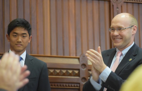 Eric Pan, left, reacts to the applause from politicians in the State Capitol.