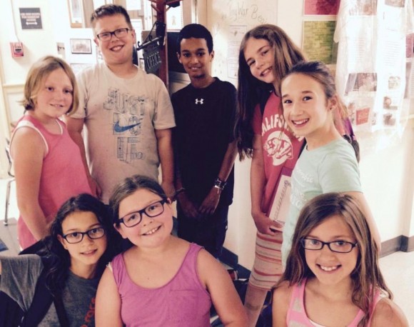 The entire committee in front of a Celebrate Center display that showcased original signage and furniture: kneeling (left to right): Anne Colangelo, Lizzy Duddy, and Lauren Presti. Standing, left to right:  Emily Nickerson,  John Coffey,  Gabe Katwaru,  Zoe Jensen, and Elise DeBernardo. 