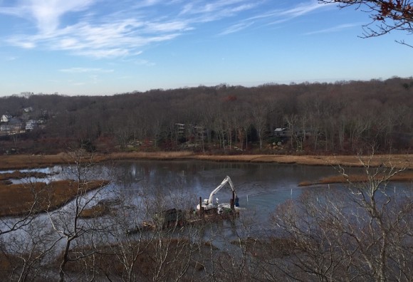 Dredging in progress on the Four Mile River upstream of the railroad bridge.