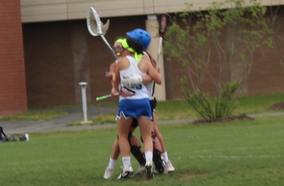 After the final whistle, Wildcat goalie Hannah Guenther shares a group with two fellow team members.