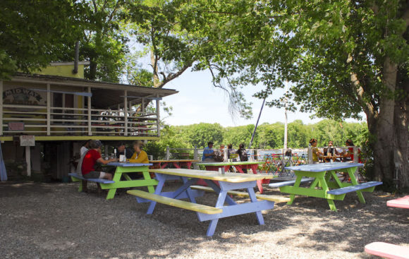Looking across the vibrant patio of 'The Blue Oar' towards the Connecticut River.