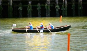In “three-hand” currach as member of Kildysart Team of Ireland, Plumleigh rows center seat in Ocean to City Festival in early June in Cork, Ireland.