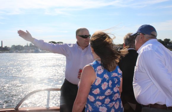 Connecticut Port Authority staff member Joe Salvatore points out a river feature to Reemsnyder and Johnson.