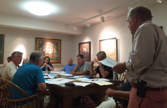 Old Lyme Town Treasurer Tim Griswold (standing) makes a point during the meeting.
