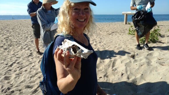 Kendall Perkins displays a skull she found during Save The Sound's Coastal Clean-up Day held yesterday at White Sand Beach.