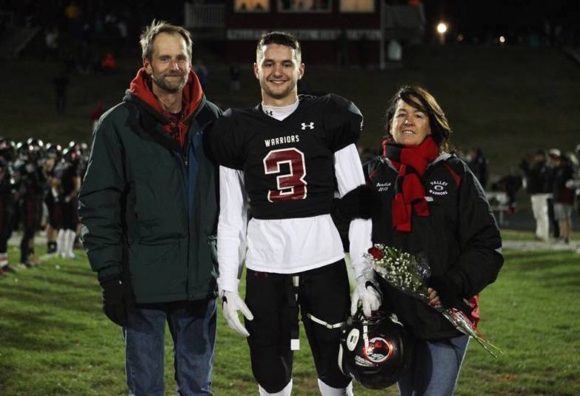 Proud parents Paul and Judy stand with their son, Lyme-Old Lyme High School senior Garrett , at Senior Night celebrations last week. Photo by Laura Matesky.
