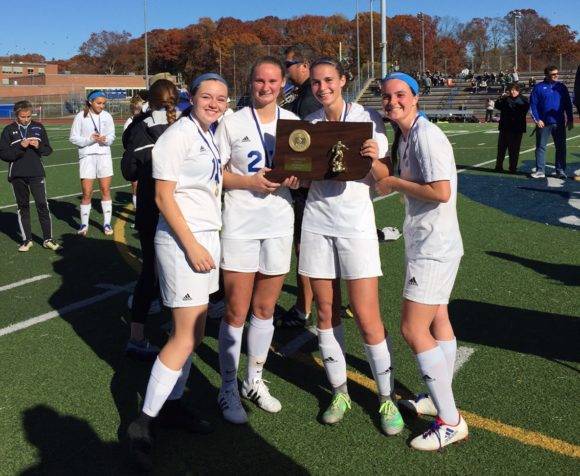 The four Wildcat seniors proudly display the trophy.