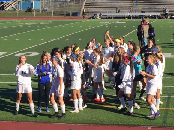 The Wildcats celebrate the moment of victory. Photo by T. Tinnerello.